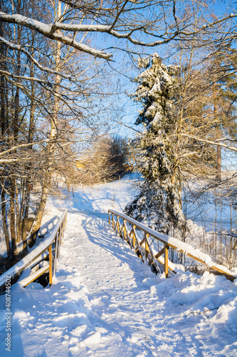 Winter view of the wooden bridge over The Kolmehaara River, Pusula, Lohja, Finland photo