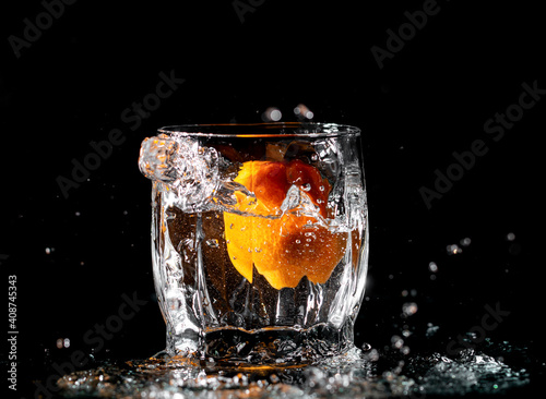 tangerine in clear water with splashes