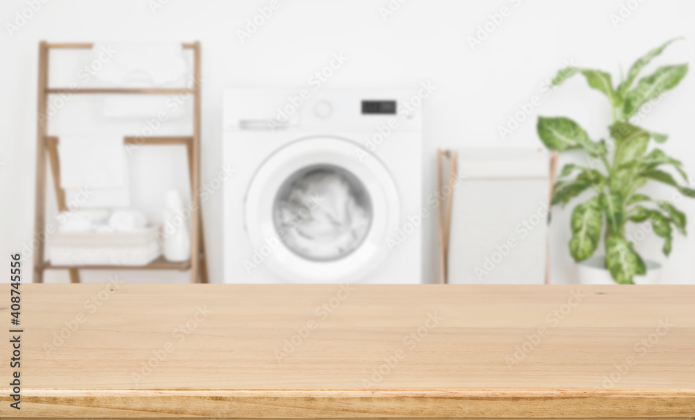 Empty wooden board over blurred laundry room washing machine background - obrazy, fototapety, plakaty 