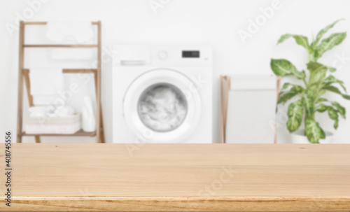 Fotografiet Empty wooden board over blurred laundry room washing machine background