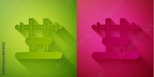 Paper cut Bench with barbel icon isolated on green and pink background. Gym equipment. Bodybuilding, powerlifting, fitness concept. Paper art style. Vector.