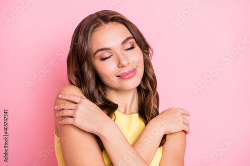 Portrait of pretty young girl closed eyes embrace shoulder imagination isolated on pink color background