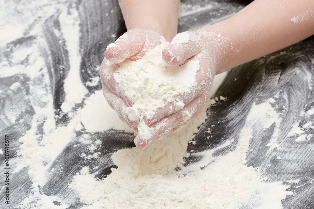 Fototapeta premium a child prepares cookie dough