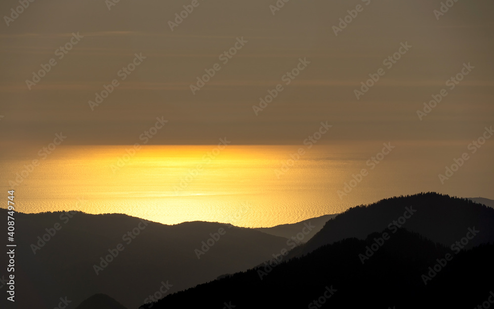 sunset in the mountains over the sea sunset in the mountains over the sea
