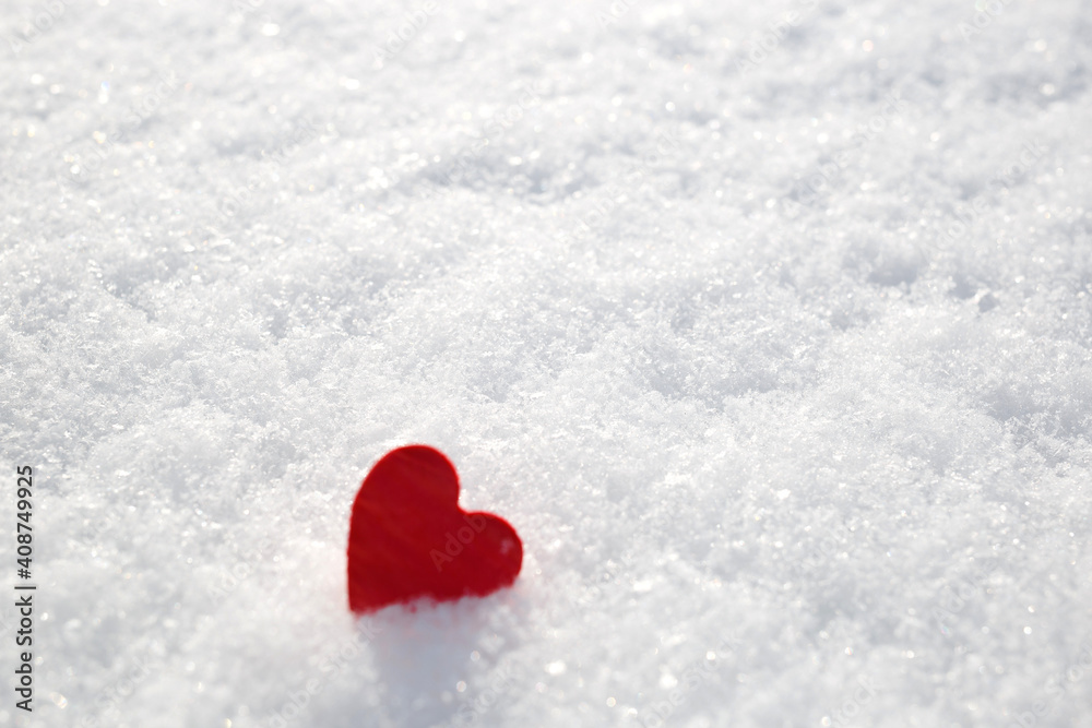 concept Valentines Day: red heart in the snow. salective focus