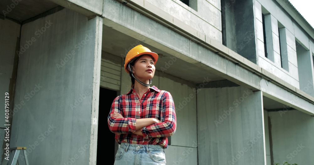 Portrait of young asian woman engineer safety equipment at construction site. Plan of construction site from ration with other worker and wearing safety equipment helmet and yellow glasses. Portrait of young asian woman engineer safety equipment at construction site. Plan of construction site from ration with other worker and wearing safety equipment helmet and yellow glasses.