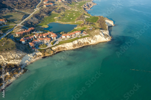 Panoramic view of picturesque landscape with green hills, golf fields and buildings near the rocky coastline of the Black sea, Thracian Cliffs golf and beach resort, Bulgaria photo