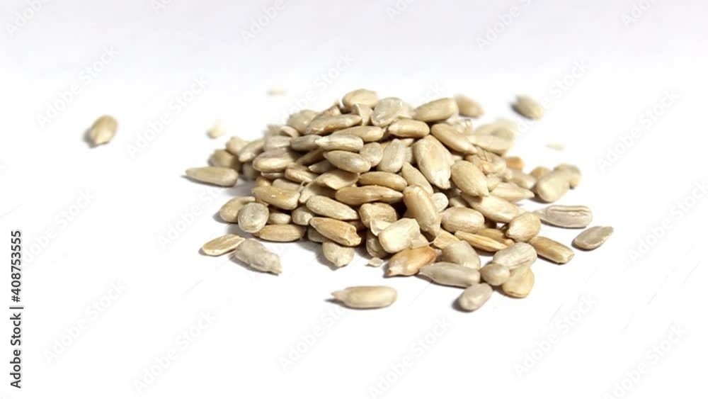 Peeled sunflower seeds on a white background. Energy supply of the body. Selective shot. Peeled sunflower seeds on a white background. Energy supply of the body. Selective shot.