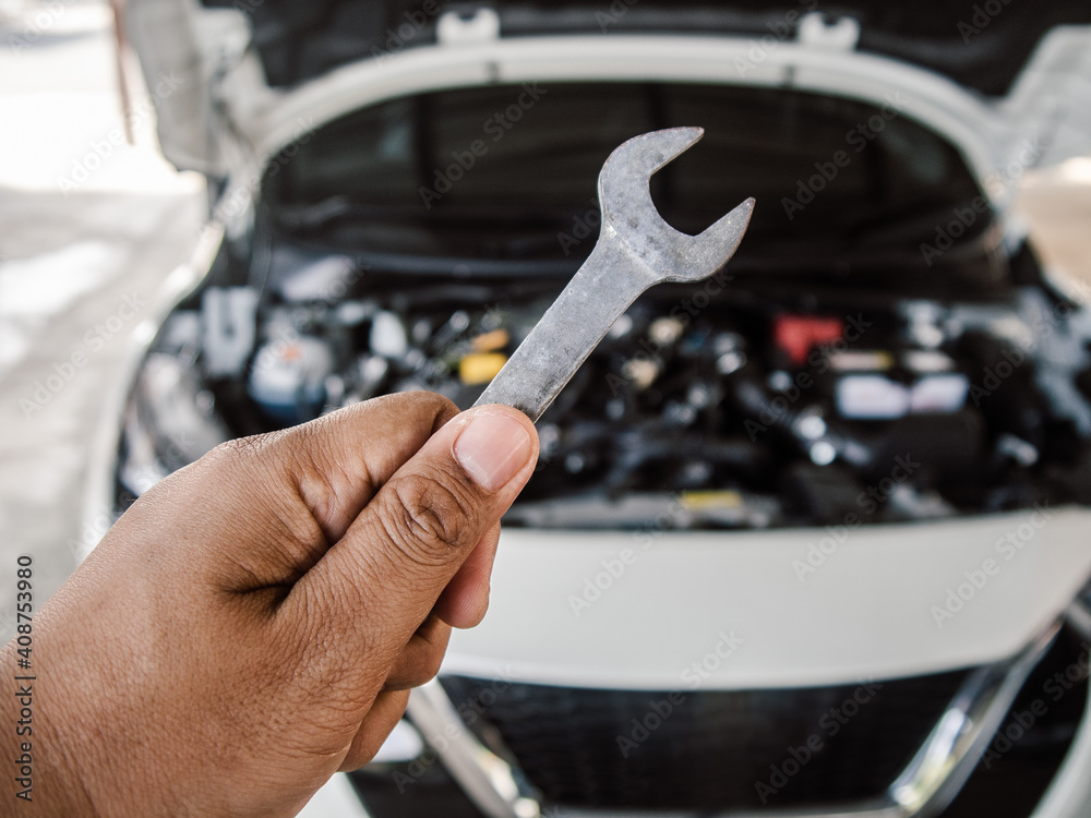Technician hand holding a old wrench for repair car Technician hand holding a old wrench for repair car