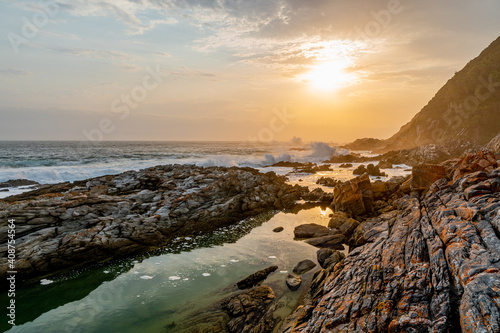Peaceful reflection of sunset sky in rock pool along the Otter Trail of the Tsitsikamma National Park, South Africa. photo