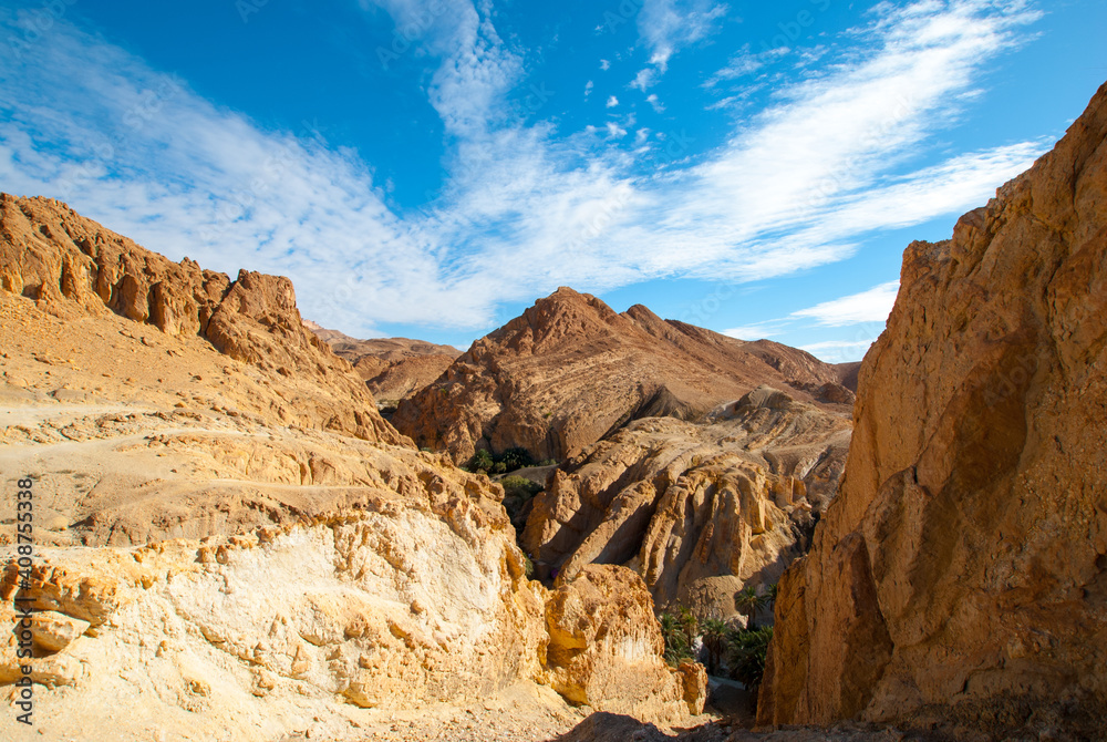 Obraz premium Mountains on the background of a blue sky with white clouds, mountain landscape Tunisia, background, wallpaper, postcard
