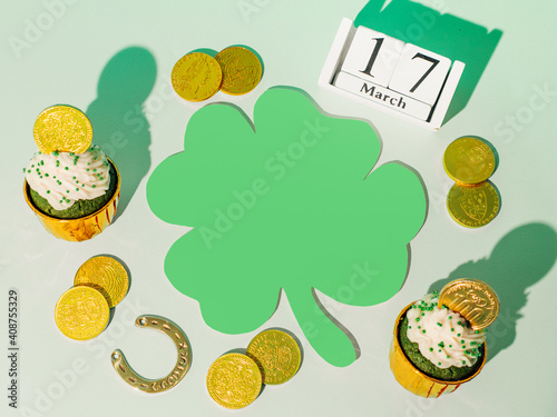 St.Patrick's day with lucky symbols. Top view of Saint Patrick's day holiday with green paper clover or shamrock leaf. Flat lay. Copy space