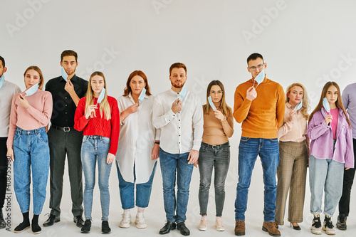 young people taking off protective medical face mask during coronavirus and flu outbreak. virus and illness protection, quarantine. COVID-2019. isolated over white background
