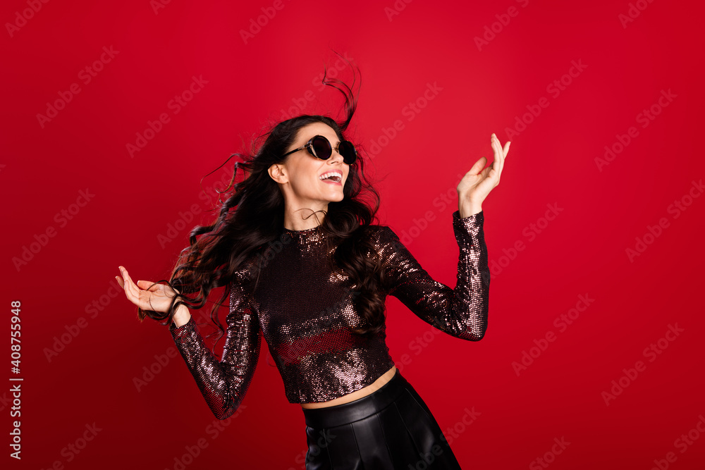 Photo of charming gorgeous woman raise hands celebrate christmas mood isolated on red color background Photo of charming gorgeous woman raise hands celebrate christmas mood isolated on red color background