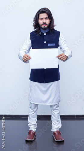 Man standing with black paper in both hands. photo