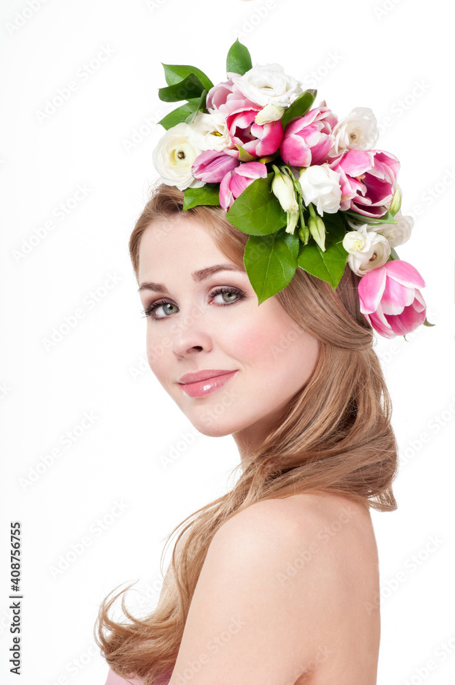 Beauty Spring Girl with Flowers Hair Style. Beautiful Model woman with Blooming flowers on her head. Smile. Spring Flower.Mother's Day. Springtime.