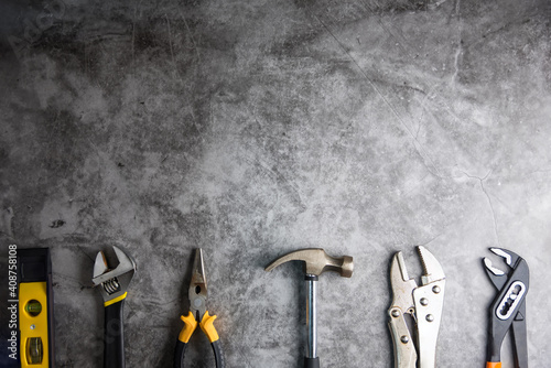 Construction tools on Gray-black cement floor background with copy space.Home Repair concept, Repair maintenance concept, Renovation concept. photo
