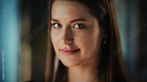 Close Up Face Portrait of a Young Creative Caucasian Female with Dark Hair Posing for Camera in Evening Dress or Blouse. Beautiful Diverse Independent Woman is Happy and Smiling.