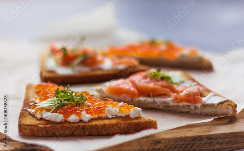 sandwiches of bread red caviar and fish