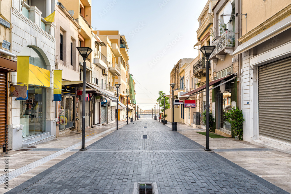 One of the main street of the Heraklion center, 25th of August. Empty street, no people. Sunny morning.