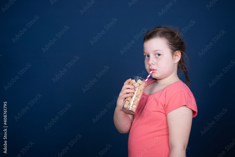 Girl drinking a glass full of sugar. Modern day to day diet, young people drinking to many soft drinks. Girl drinking a glass full of sugar. Modern day to day diet, young people drinking to many soft drinks.