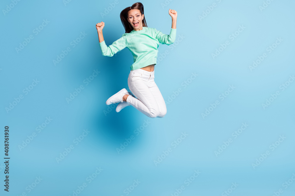Full length body size view of lovely cheerful carefree teen girl jumping having fun isolated over bright blue color background