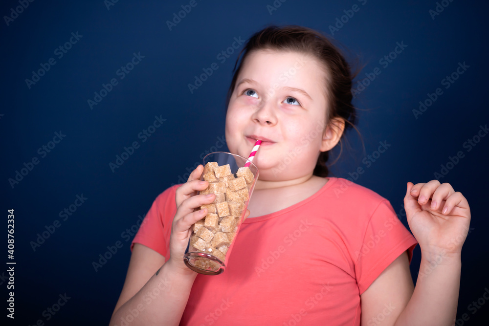 Girl drinking a glass full of sugar. Modern day to day diet, young people drinking to many soft drinks. Girl drinking a glass full of sugar. Modern day to day diet, young people drinking to many soft drinks.