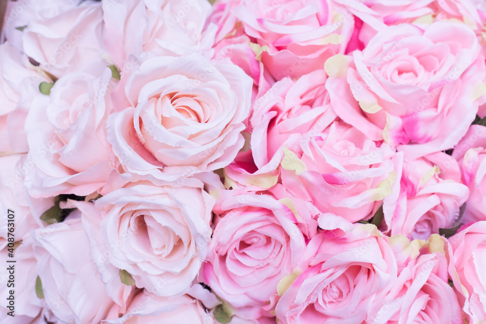 Close up of many fabric pale pink roses with blurred  background.