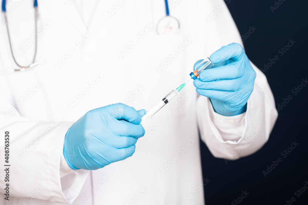 Close up of hands of doctor preparing for vaccination Close up of hands of doctor preparing for vaccination