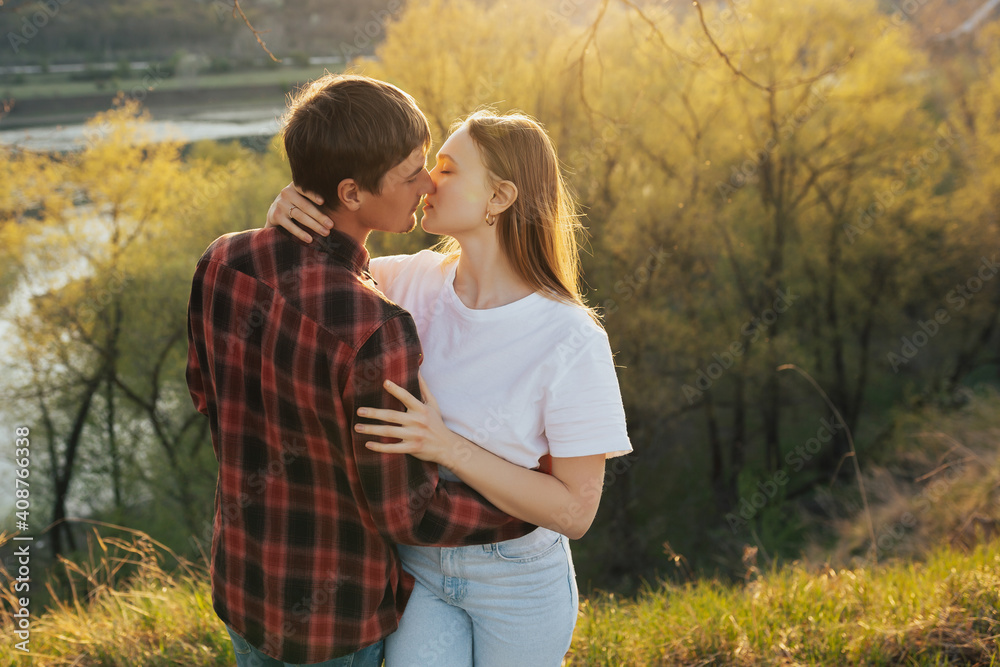 Two young people in the light of sun hugging and want to kiss at nature. Two young people in the light of sun hugging and want to kiss at nature.