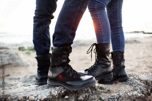 Newlyweds have a rest in the mountains in black boots, independence concept