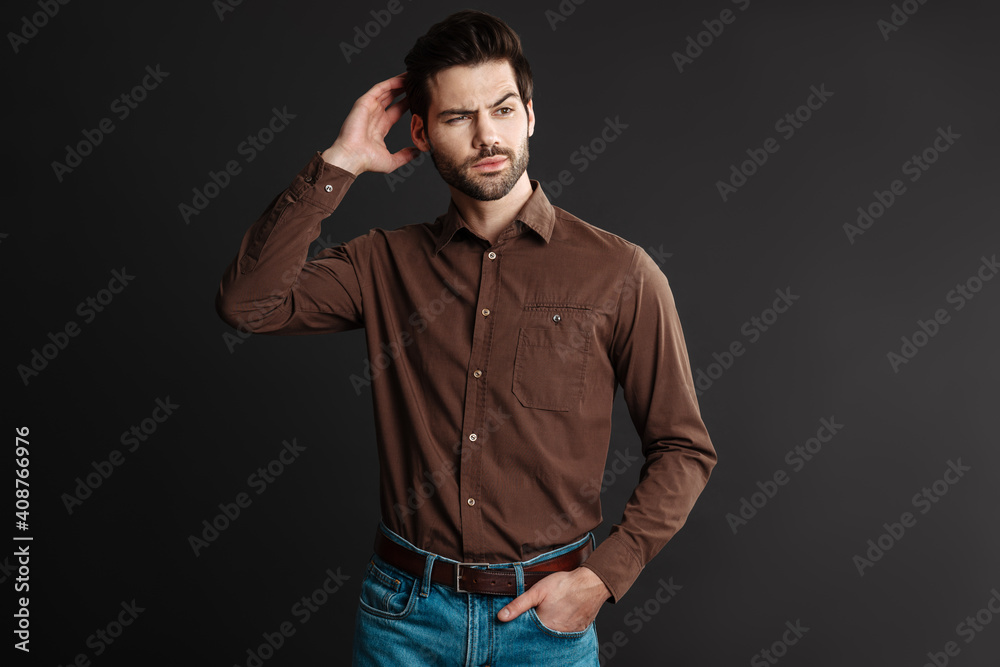 Thinking handsome unshaven guy posing and looking aside