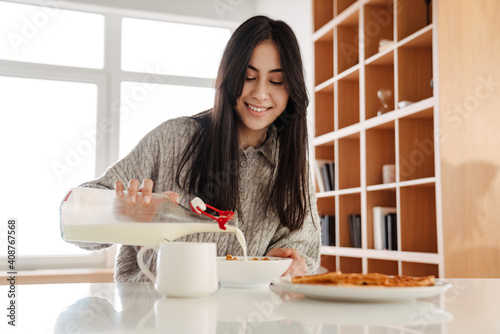 Attractive healthy young woman eating cereal