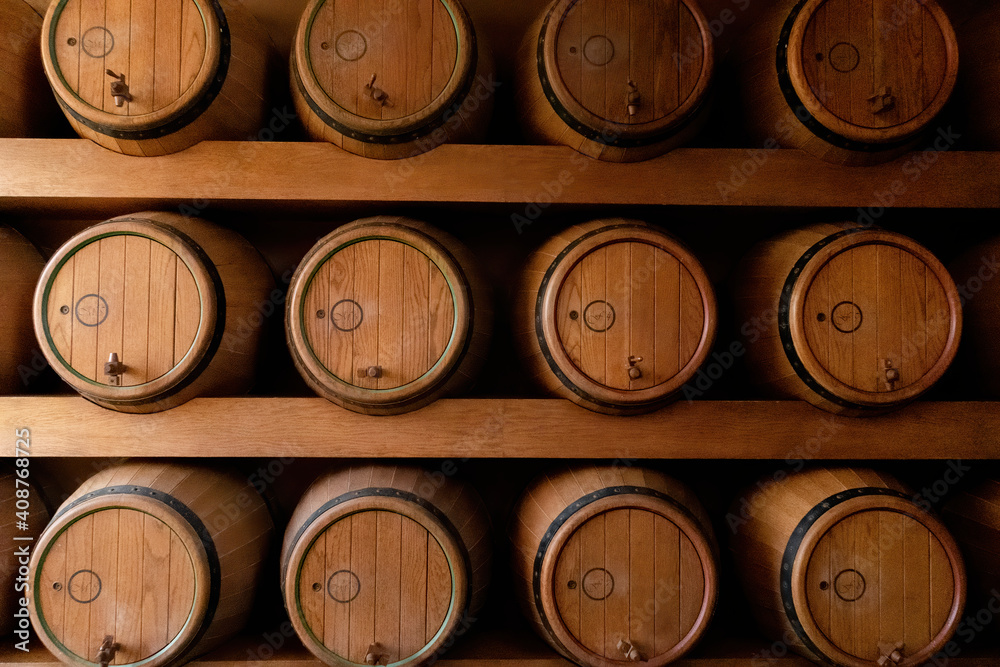 Wooden wine barrels placed on wooden shelves