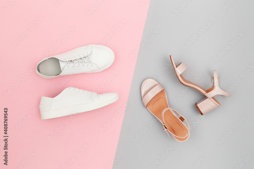 White sneakers and pink heeled sandals on grey and pink paper background. Stylish spring or summer woman's shoes in pastel colors. Trendy beauty female fashion background. Flat lay, top view. - obrazy, fototapety, plakaty 