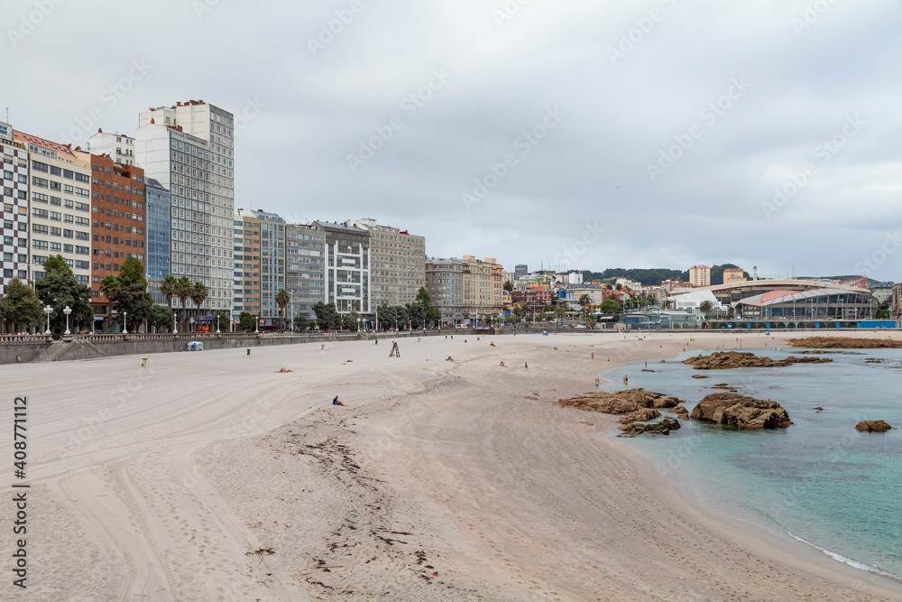 View of the empty Orzan and Riazor beaches on a cloudy and cold summer day, in the city of La Coruna, in the north of Galicia.