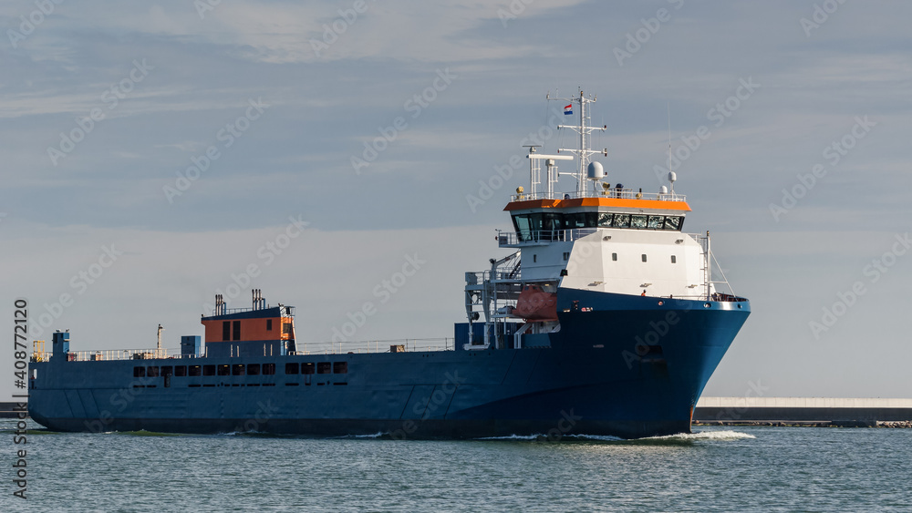 MERCHANT VESSEL - A ship with a load is traveling on a waterway