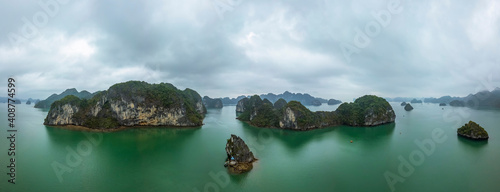 Panoramic view of Ha Long Bay, Vietnam. Cloudy and moody. Scattered limestone islands. Aerial view.