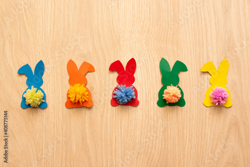 Garland of colourful bunnies on wood table. DIY for Easter