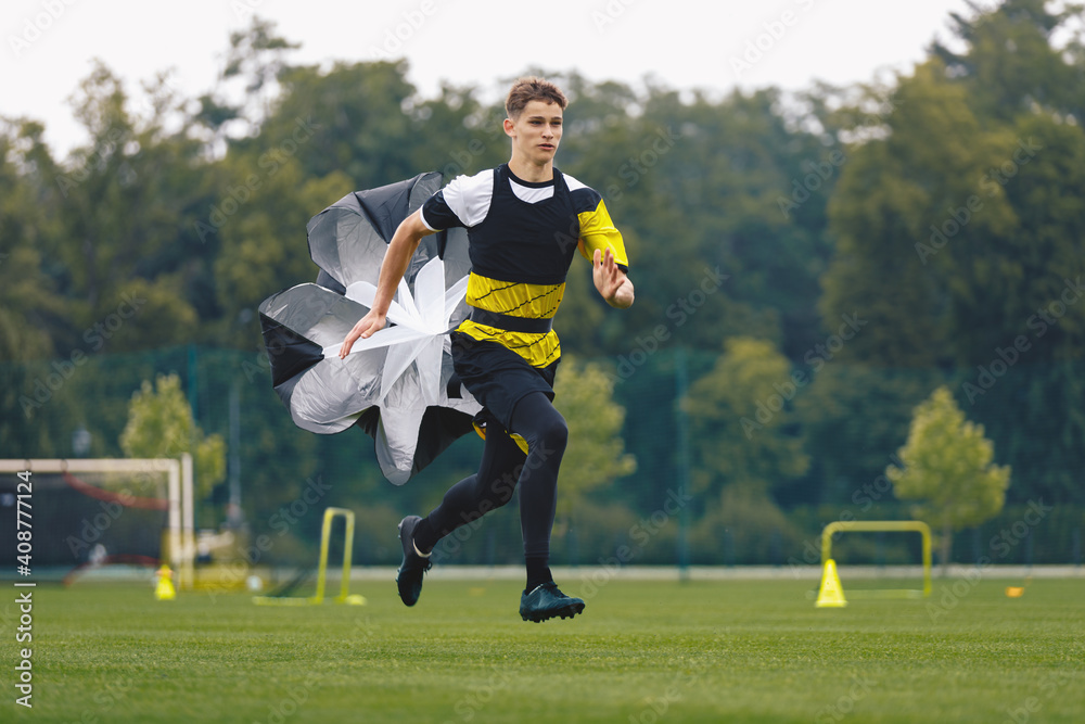 Youth Football Player Running with Parachute. Soccer Football