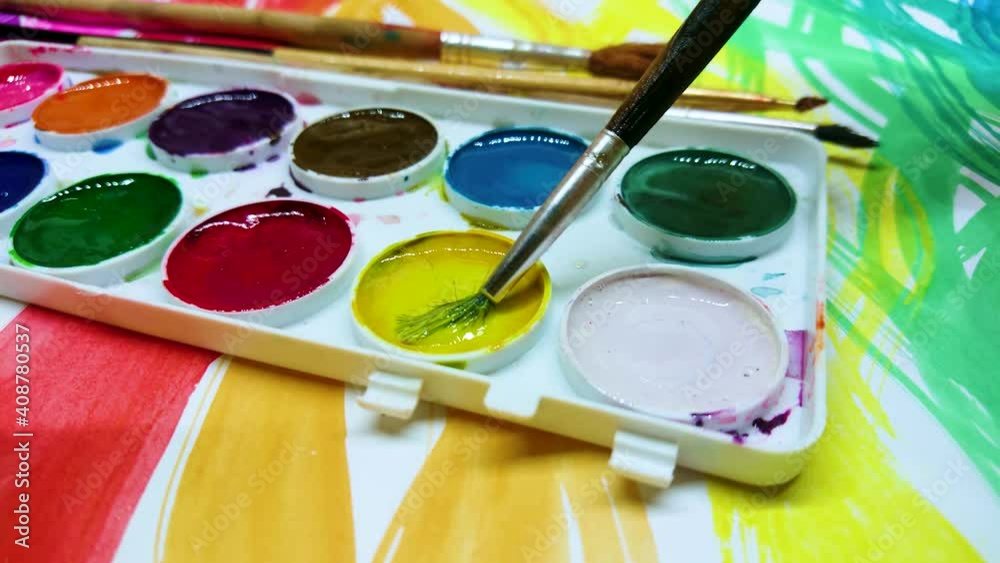 Process of drawing hearts by a brush with a yellow color