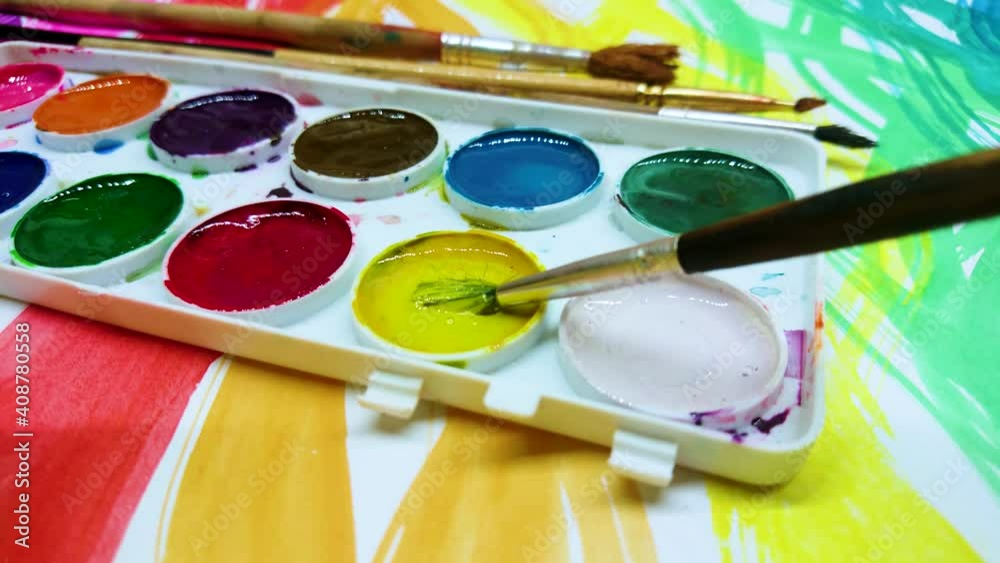 Process of drawing hearts by a brush with a yellow color