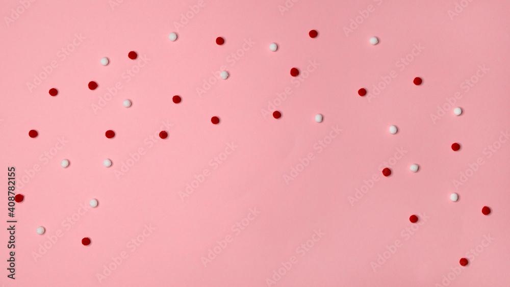 Red and white confetti soft balls on gently pink background. Festive holiday pattern. Happy Easter Day holiday 
