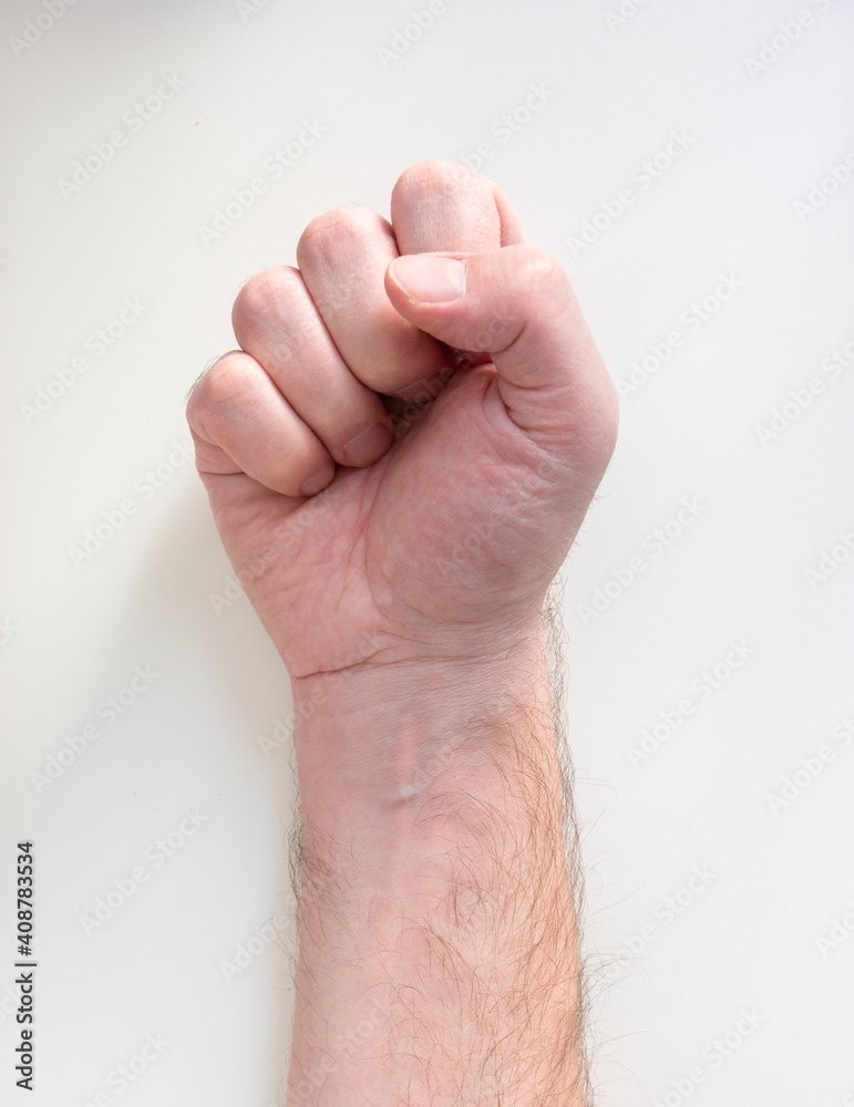 Caucasian male hand making a closed fist isolated on white top view Caucasian male hand making a closed fist isolated on white top view