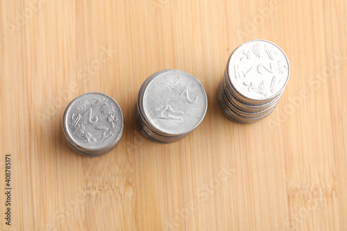 Indian two rupee coins arrange in graph on wooden board