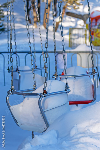 The children's carousel is not used in winter and is covered with snow