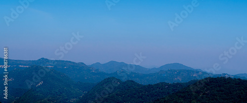 Spectacular blue and cyan mountain range  view under blue sky during daytime.