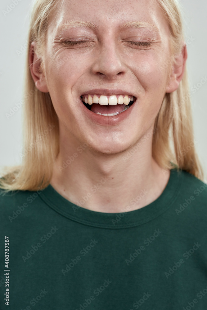 Portrait of happy young caucasian fair haired man laughing Portrait of happy young caucasian fair haired man laughing