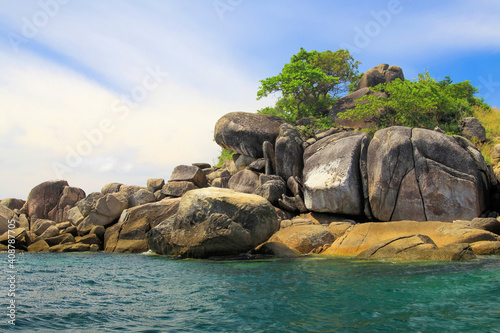 View on remote isolated tiny tropical derserted empty paradise island of rocks and boulders - andaman sea, Ko Lipe, Thailand