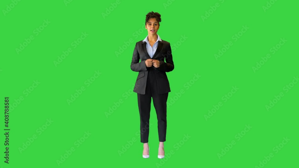 Young black businesswoman speaking to the camera on a Green Screen, Chroma Key. Young black businesswoman speaking to the camera on a Green Screen, Chroma Key.